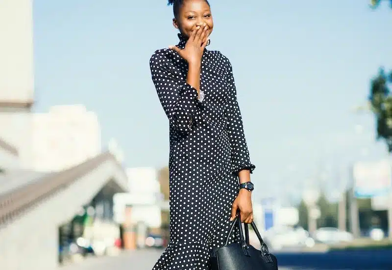 Woman Standing at Outdoors While Holding Black Leather Bag