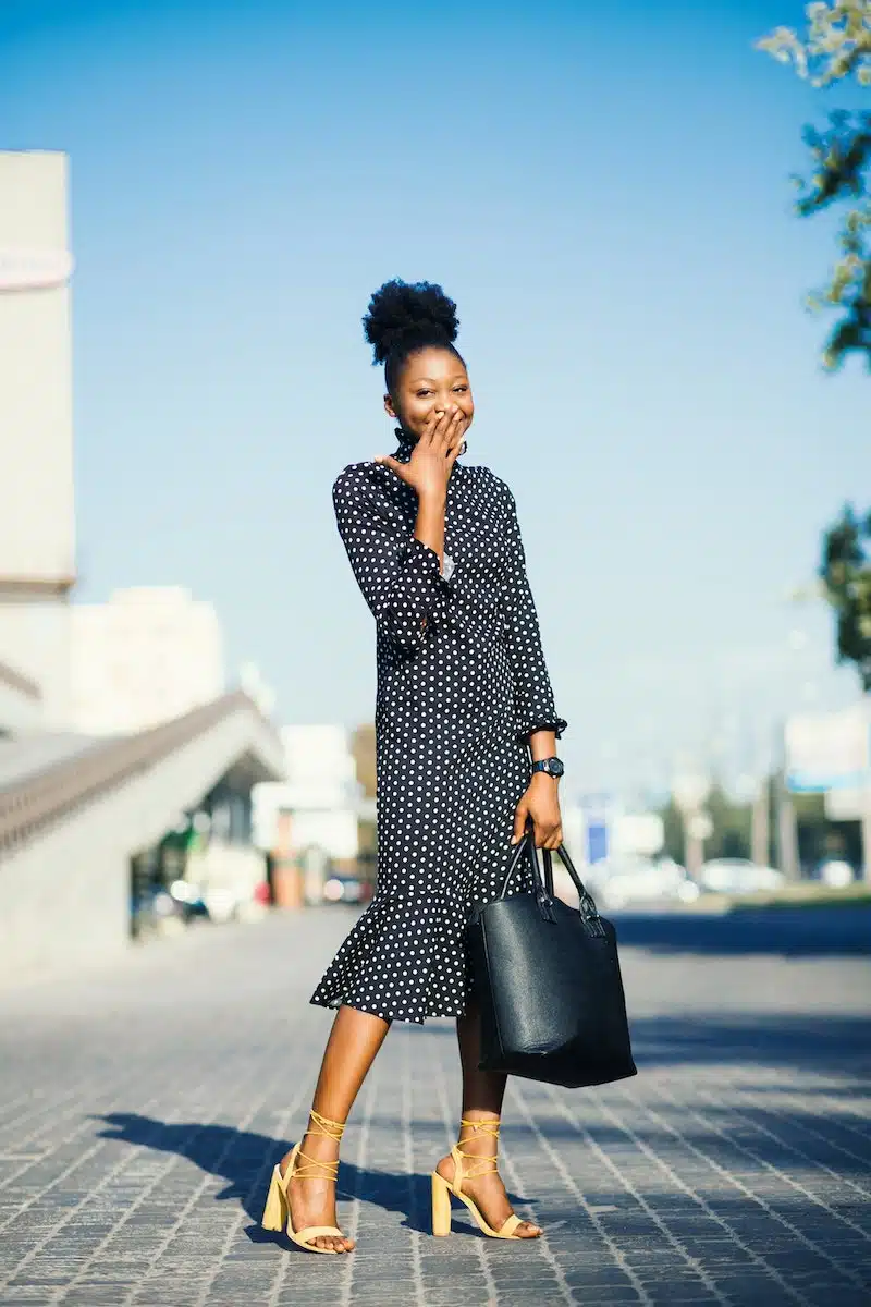 Woman Standing at Outdoors While Holding Black Leather Bag